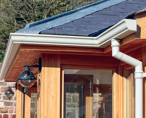 Cream moulded ogee guttering with traditional round cast swan neck and down pipe cream moulded ogee guttering with traditional round cast swan neck and down pipe