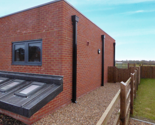 Guttercrest Aluminium Square & Rectangular Downpipe in black fitted to residential property guttercrest aluminium square and rectangular downpipe with hopper in black
