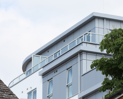 Guttercrest Aluminium Square & Rectangular Downpipes fixed to Station View building | Surrey guttercrest aluminium square and rectangular downpipes in grey including box guttering hopper heads fascia soffit