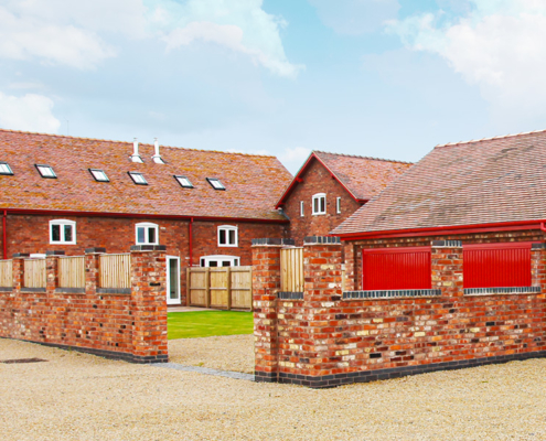 red-half-round-gutters-and-downpipes